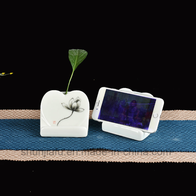 M&atilde;o desenho tipo vaso de cer&acirc;mica suporte do telefone m&oacute;vel