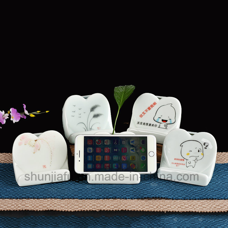 M&atilde;o desenho tipo vaso de cer&acirc;mica suporte do telefone m&oacute;vel