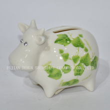 Vaca pequena de cerâmica com cofrinho verde decalques